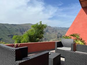 a balcony with chairs and a view of the mountains at Casa La Cabezada in San Sebastián de la Gomera