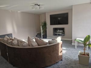 a living room with a couch and a tv at Warlands Farm Guest House in Durham