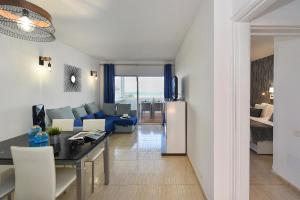 uma cozinha e sala de estar com um sofá e uma mesa em Apartment Aida 202 by VillaGranCanaria em Playa del Inglés
