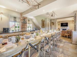 a large dining room with a long table and chairs at Willington Lodge in Hanmer