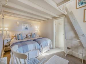 a bedroom with two beds and a desk and a staircase at Willington Lodge in Hanmer