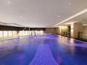 a swimming pool with purple tiles in a building at Amazing apartment in La Env a with private terrace in La Envia