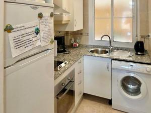a kitchen with a washing machine and a sink at Amazing apartment in La Env a with private terrace in La Envia