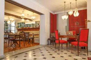 a restaurant with a table and chairs and a laptop at Alma Histórica Boutique Hotel in Montevideo