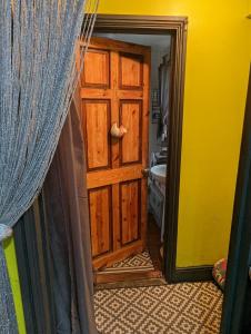 a wooden door in a room with a curtain at Quiet Quaint & Quirky House Colchester Town Centre in Colchester