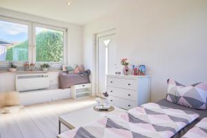 a living room with a couch and a window at Ferienhaus Ostsee in Dorf Mecklenburg