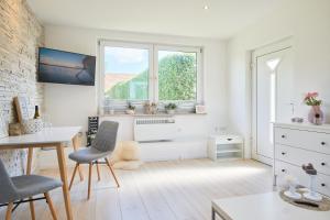 a white room with a window and a desk and chairs at Ferienhaus Ostsee in Dorf Mecklenburg
