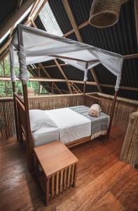 a bed in a room with a mosquito net at La Manigua Lodge in La Macarena
