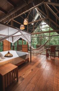 a bedroom with a hammock in a tree house at La Manigua Lodge in La Macarena