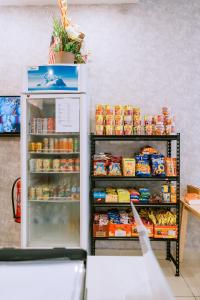 a refrigerator filled with lots of food in a store at Chill Suites Langkawi in Kuah