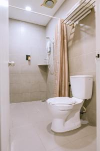 a bathroom with a toilet and a shower at Chill Suites Langkawi in Kuah