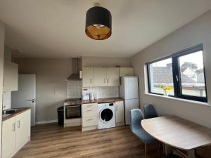 a kitchen with a table and a sink and a dishwasher at Top of the Town No.5 in Cootehill