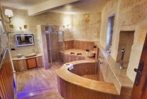 a large bathroom with a tub and a shower at La Perla Cave Cappadocia in Urgup