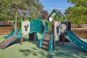 a playground with a slide in a park at mobil home tout confort 6 personnes climatisé au pied du Luberon in La Roque-dʼAnthéron