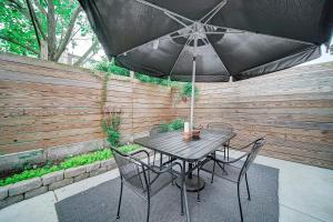 a table and chairs with an umbrella on a patio at Artsy Hidden Gem ll -Free Parking --- in Philadelphia