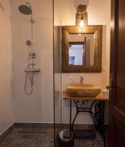 a bathroom with a sink and a mirror and a shower at Zengő in Miercurea-Ciuc