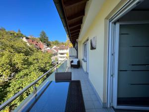 a balcony of a house with a bench on it at Deluxe Apartment Baden-Baden in Baden-Baden