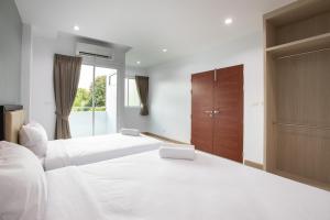 Postel nebo postele na pokoji v ubytování Green Hotel Phuket