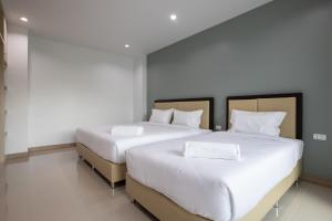 Postel nebo postele na pokoji v ubytování Green Hotel Phuket
