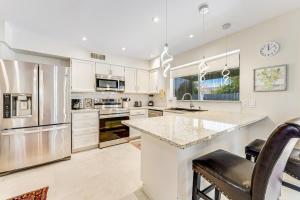a kitchen with white cabinets and stainless steel appliances at Plant Your Feet in Phoenix