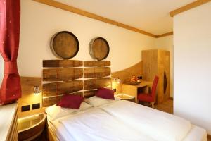 a bedroom with a bed with three mirrors on the wall at Agriturismo Eredi di Cobelli Aldo in Lavis