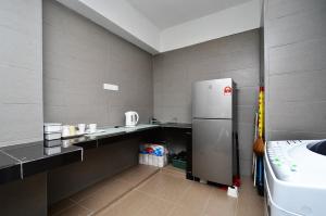 a small kitchen with a refrigerator and a sink at Menjalara Kepong Desapark & MITEC 中文房东-Room Only in Kuala Lumpur