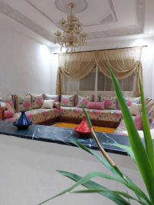 a living room with a couch and a table at Majorelle appartement in Fès