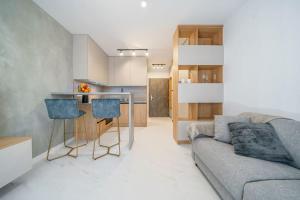 a living room with a couch and a kitchen at Style apartment studio Kabeny in Michalovce