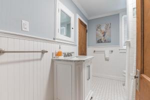 a white bathroom with a sink and a mirror at Beach Block-Ocean Views from Balconies-Parking Unit 2 in Ventnor City +21 photos