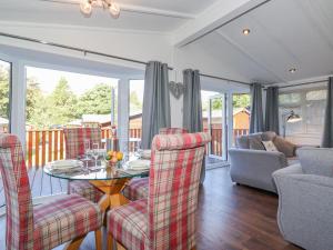 a living room with a table and chairs at Fell Foot Lodge in Windermere