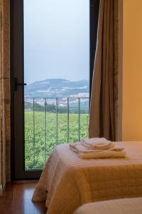 a room with a bed and a window with a view at Braga House & Wine in Braga