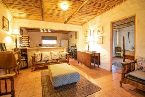 a living room with a couch and a table at Ironstone Cottage in Graaff-Reinet