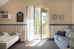 a bedroom with a bed and a couch and a sliding glass door at Dwór Złotopolska Dolina Mansion House in Trębki +33 photos