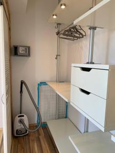 a kitchen with a sink and a vacuum at Apartment Rebe in Schweinfurt