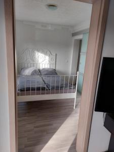 a bedroom with a bed and a mirror at Schöne Wohnung direkt am Bach in Neunkirchen am Sand