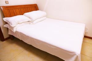 Cama o camas de una habitación en Yabuli Qingyun County Xin Ding Apartment Hotel