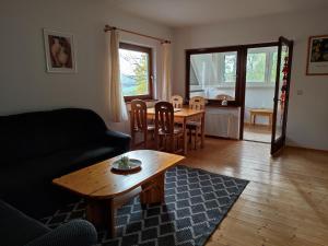 a living room with a couch and a table at Ferienwohnung Fuchs & Hase in Kronenburg