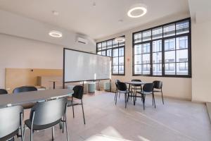 a meeting room with a large screen in a building at Camplus Regio Parco in Turin