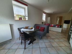 a living room with a table and a couch at Belroki Ranch in Waldeck