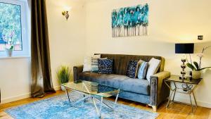 a living room with a couch and a table at Sunshine Place St. Albans in St. Albans