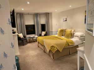a bedroom with a bed with a yellow bedspread at The Seaview Hotel And Restaurant in Seaview