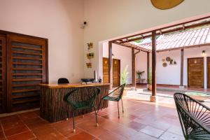a room with chairs and a desk in a house at La Mello Adventure Lodge in Palomino