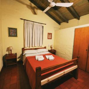 a bedroom with a large bed with two towels on it at Los Zarzos in Mina Clavero