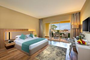 a hotel room with a bed and a balcony at Zen Resort Sahl Hasheesh by TBH Hotels in Hurghada