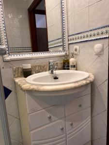 a bathroom with a sink and a mirror at MoMA Meanas Aviles Centro in Avilés