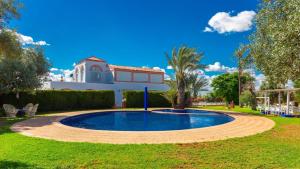 a swimming pool in the yard of a house at Finca la Cañera Alcalá de Guadaira by Ruralidays in Alcalá de Guadaira