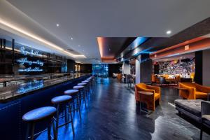 a bar at a restaurant with stools at Generator Hotel Washington DC in Washington, D.C.