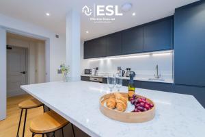 a kitchen with a bowl of bread and a bottle of wine at High Quality 2 Bedroom Church Apartment with Free Parking in Shrewsbury