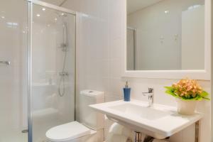 a bathroom with a sink and a shower and a toilet at Casa da Praça Apartments - by Casas na Ilha in Funchal +31 photos