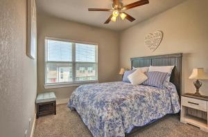 a bedroom with a bed and a ceiling fan at College Station Townhome with Furnished Patio! in College Station